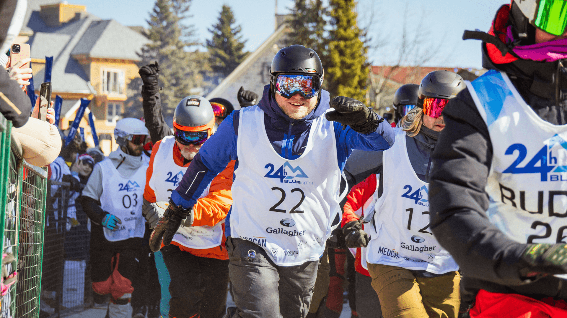 Skiers and Snowboarders running out of the starting gate to kick of 24 hour Blue Mountain.