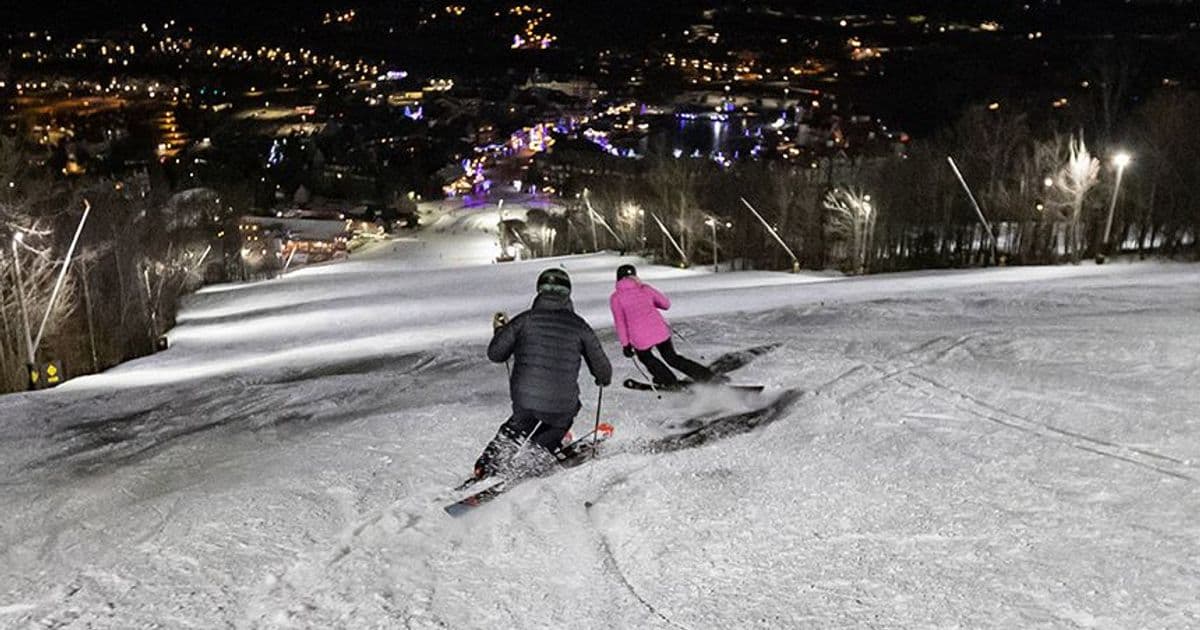 Two skiiers racing down the slopes for midweek night skiing at Blue.