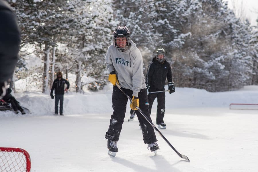 Group of men playing a pick up game of hockey on the mountaintop Shinny Pad.