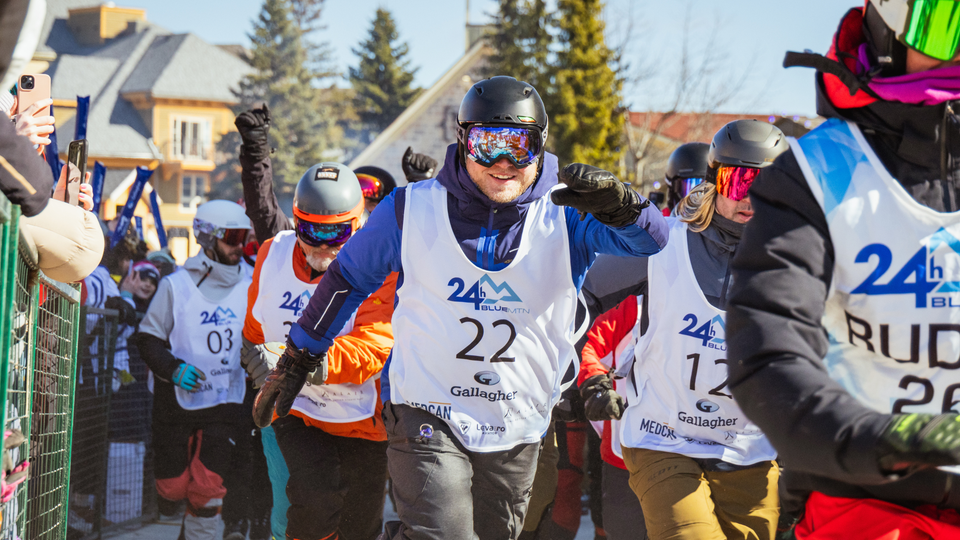 Skiers and Snowboarders running out of the starting gate to kick of 24 hour Blue Mountain.