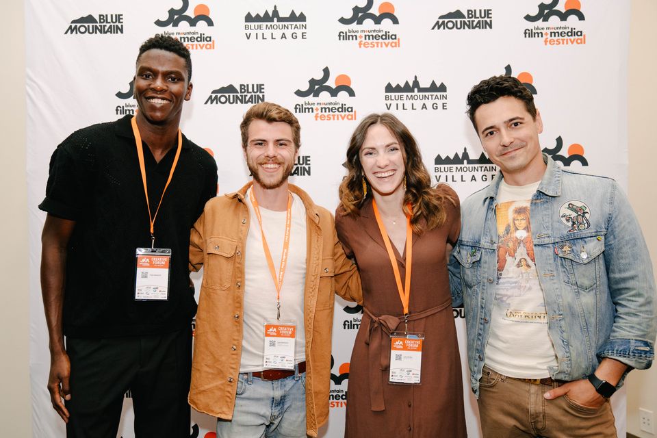 Renowned digital content creators, Tope Babalola, Zach Ramelin, Julie Nolke, and Tanner Zipchen, pose on the orange carpet at Blue Mountain Film and Media Festival.