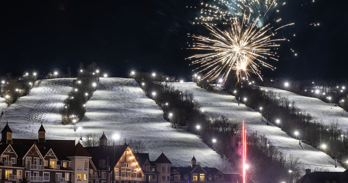 Bursts of Fireworks light up the night sky over the glowing Mountain and Village in celebration of New Year's Eve at Blue.